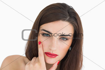 Woman touching her chin while looking at camera
