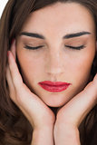 Woman with red lips with her eyes closed