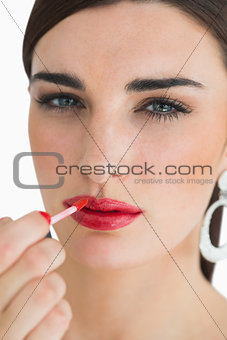 Woman colouring her lips