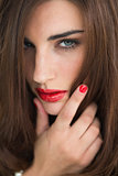 Woman with red lips looking thoughtful