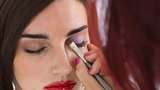 makeup artist applying eye shadow