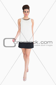Woman walking while wearing a dress