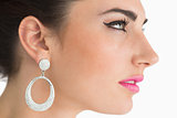 Woman wearing earrings in sixties makeup