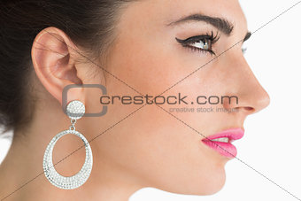 Woman wearing earrings in sixties makeup