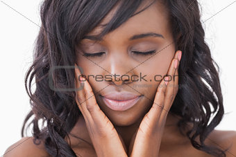 Woman hands in face while eyes closed