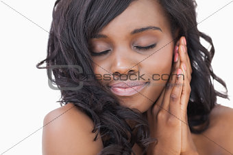 Woman with hands at face eyes closed