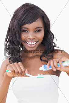 Woman holding a toothbrush while smiling