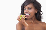 Woman holding an apple smiling
