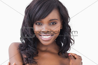 Smiling woman with hands on her shoulders