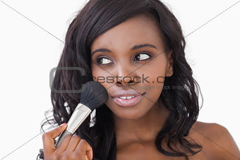 Woman using makeup brush