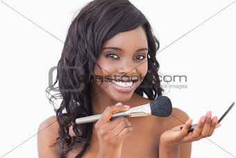 Woman holding powder and a brush