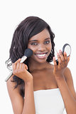 Woman smiling while holding powder compact