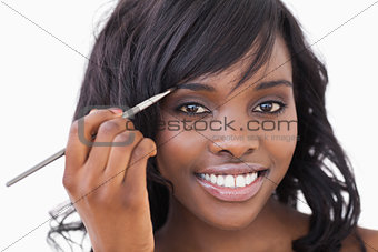 Woman using an eye shadow brush