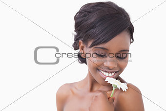 Smiling woman smelling flower