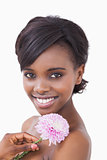 Woman smiling and holding a pink coloured flower