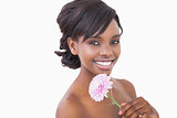 Woman holding pink coloured flower