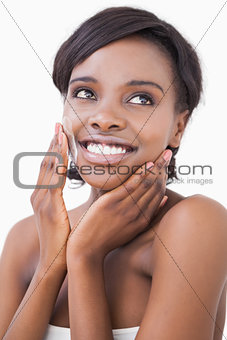 Happy woman putting on face cream