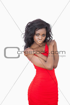 Woman standing against white background looking seductive