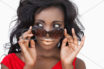 Woman tilting sunglasses