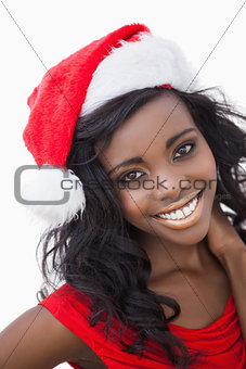 Woman wearing red dress and Santa Claus hat