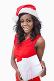 Woman standing holding a gift while smiling