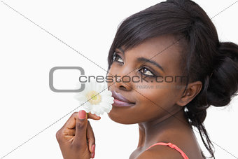 Girl smelling a daisy