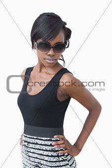 Woman wearing black dress and sunglasses