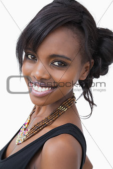 Woman in tribal style necklace smiling