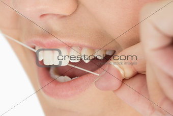 Close up of mouth and dental floss
