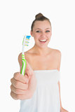 Happy woman showing a toothbrush