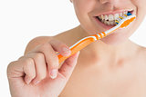 Smiling woman washing her teeth