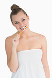 Cheerful woman washing her teeth