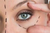 Woman opening the green eye with her hand