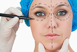 Plastic surgeon drawing on face