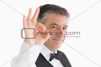 Well-dressed waiter making ok sign