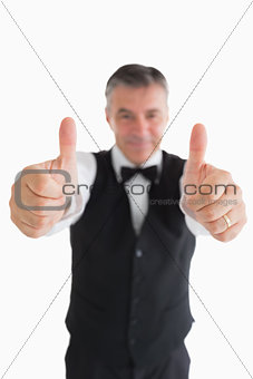 Smiling waiter having thumbs up