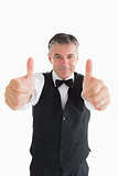 Well-dressed waiter having thumbs up