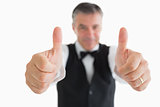 Cheerful waiter having thumbs up