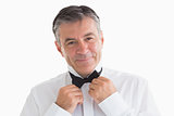 Well-dressed man adjusting his bow tie