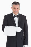 Smiling waiter holding a towel