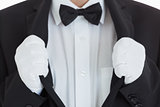 Well-dressed waiter clinging at his jacket