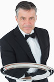 Waiter holding out silver tray