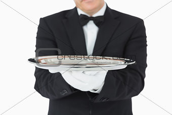 Man holding a silver tray with both hands