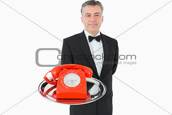 Waiter holding red phone