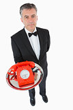 Waiter holding a red dial phone