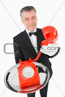 Waiter giving the phone to someone