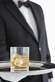 Man holding tray with whiskey