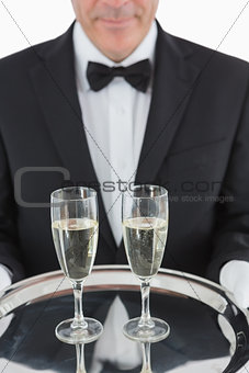 Man holding tray with champagne