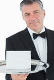 Waiter holding tray with paper