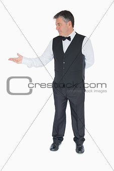 Waiter presenting something to the left